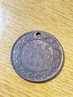 Reverse side showing ONE CENT 1903 with maple-leaf wreath, drilled hole visible