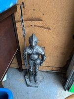 Full front view of metal knight doorstop on hexagonal base