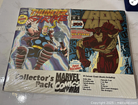 Front of sealed pack showing Thunderstrike and Iron Man covers