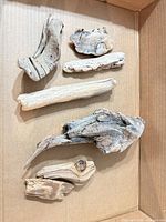 Seven driftwood pieces inside box, overall view