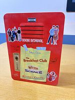 Front of red metal tin showing High School Flashback Collection graphics