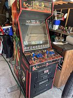 Full view of Midway Killer Instinct 2 upright arcade cabinet in garage