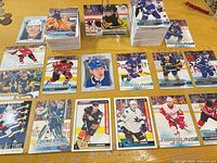 Stacks of Upper Deck hockey cards and multiple Young Guns, UD Portraits and Canvas singles spread out