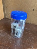 Jar containing several small cardboard boxes with vintage car images