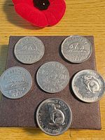 All six Canadian 5-cent coins displayed on board