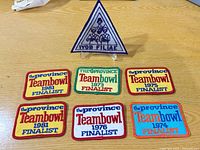 All seven embroidered patches grouped on table