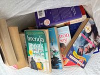 Overhead view inside bag showing multiple romance paperbacks; Brenda Novak title in foreground
