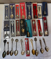 Group shot of all approximately 26 souvenir spoons showing boxed and loose pieces