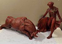 Matador and bull figurines side by side