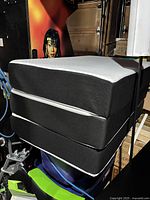 Stacked mattress and topper showing side profile and covers