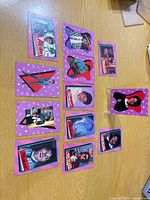 Group shot of approximately 12 Michael Jackson promo trading cards on table