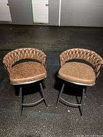 Front angled view of both stools showing upholstery, frames