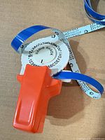 Radio Shack embossing label maker with blue tape visible