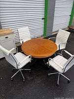 Table and four chairs grouped together outdoors