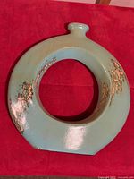 Front view of seafoam ceramic ring vase showing gold distressing and overall shape