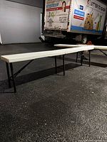 Both benches set up on pavement showing length and leg style