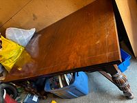 Angled view of full dining table showing veneer top and leg detail