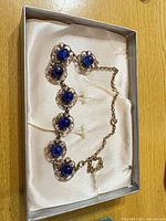 Full necklace in box showing overall design and clasp