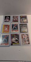 Nine sleeved baseball cards laid out 3x3