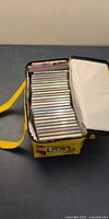 Bag opened displaying all CD jewel cases neatly stacked
