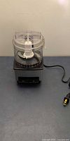 Full view of Cuisinart mini food processor showing bowl, lid, base and cord