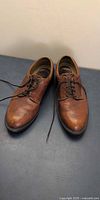 Top view of full pair of brown Rockport leather lace-up shoes