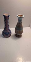 Two pottery vases side by side showing designs and shapes