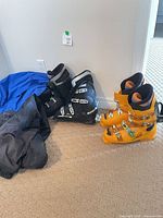 Salomon orange and Lange black ski boots side by side for overall view