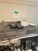 Full VCR with remote, power cord and paperwork on top