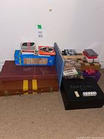 Group shot of all board games, card decks, dice, dominoes, SurfLink box