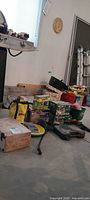 Overall lot view with boxes, hose, tool kit, bag