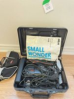 Open hard case showing camcorder components, manual, cables, soft pouch