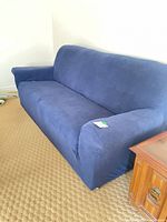 Full view of sofa with blue slipcover