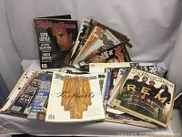 Lot of approximately 30 vintage Rolling Stone magazines visible, with a range of covers including Kevin Costner and other notable figures.