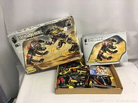 Overall view of the Bionicle Technic box, instruction manual, and loose LEGO Technic parts seen in a cardboard tray.