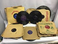 Photo showing a collection of approximately 60+ 78 rpm records with paper sleeves, various labels visible including Decca, Columbia and Audiophile