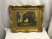 Full view of the framed antique photo or print depicting a landscape scene with figures and trees, showcasing the overall size and frame design.