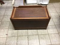 Top view of rectangular wooden kids toy chest showing lid and surface wear.