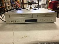 Front view of Citech VHS and DVD combo player showing tape slot, disc tray, control buttons, and input/output ports.