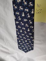 Front view of navy tie with Dalmatian puppy pattern