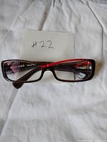 Front view of rectangular Alain Mikli frame showing pattern and red accent