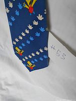 Front of tie showing Bart Simpson and handprint pattern