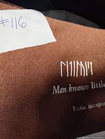 Front of brown pouch showing runic embroidery and phrase