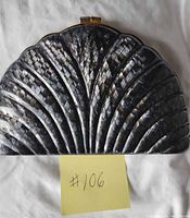 front view of clam-shaped purse showing mosaic exterior design