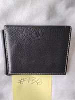Front exterior of black leather wallet showing pebbled texture and stitching