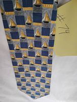 Full view of Dunhill tie displaying sailboat and stripe pattern
