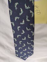Full view of navy tie showing fish motif