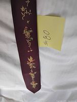 Full view of maroon tie with painted design