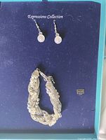 Boxed set showing earrings and bracelet
