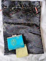Drawstring sack and blue change purse together for scale